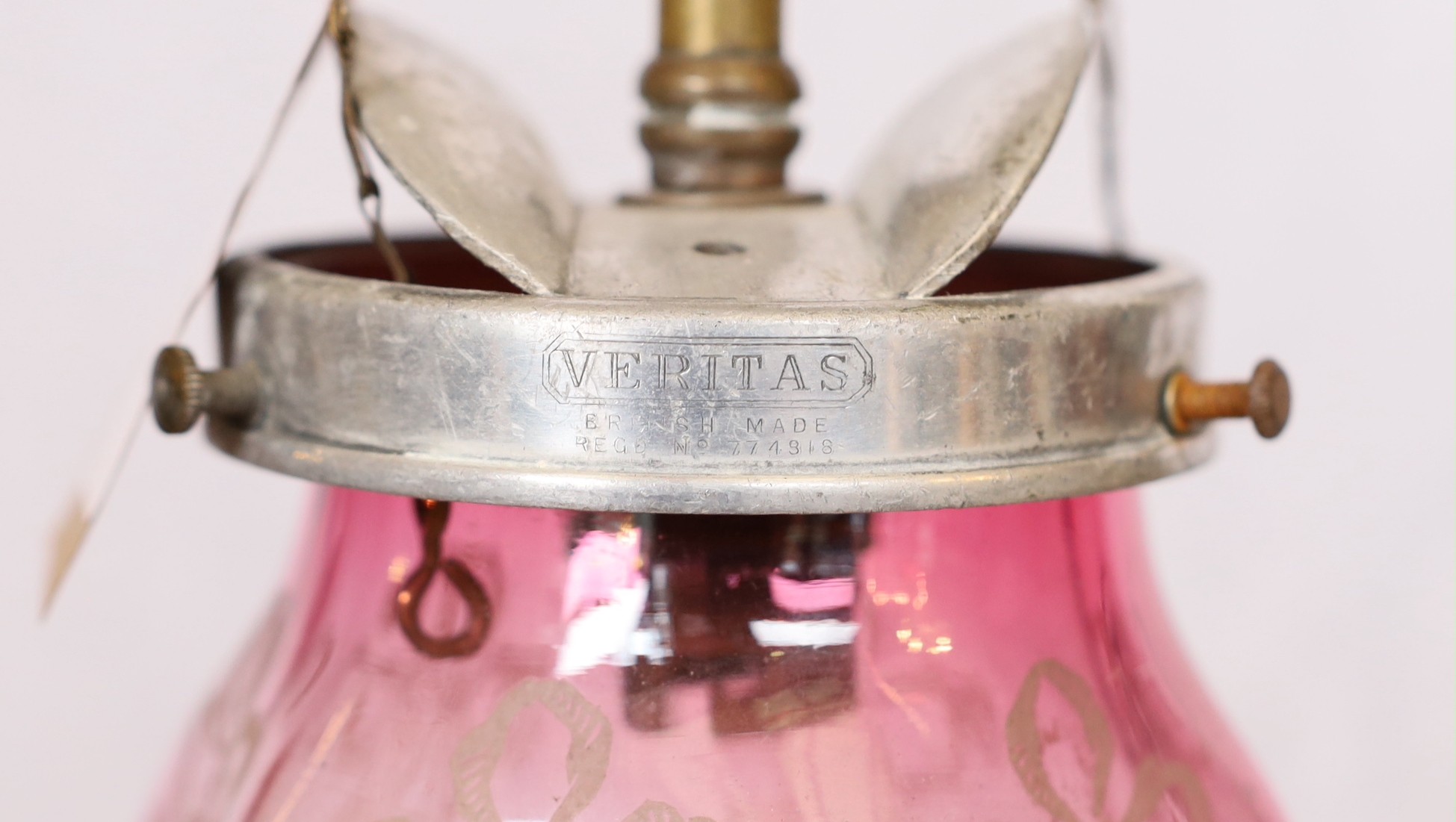An early 20th century English brass gasolier light fitting, converted to electricity, with pink tinted etched glass shade, height 50cm